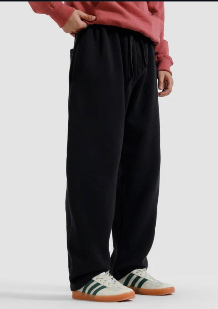 Person wearing black pants and a red sweatshirt on a white background