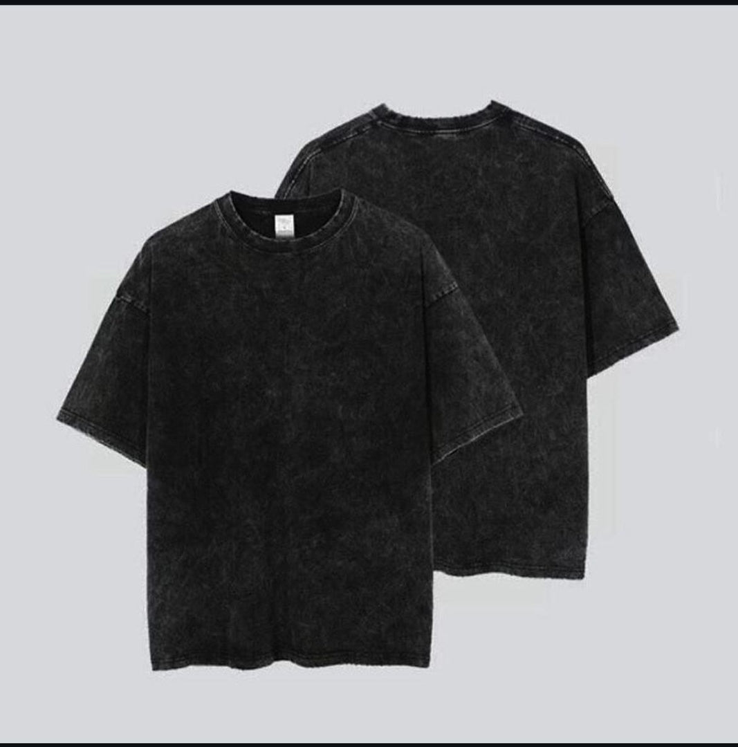 Two black t-shirts on a light gray background